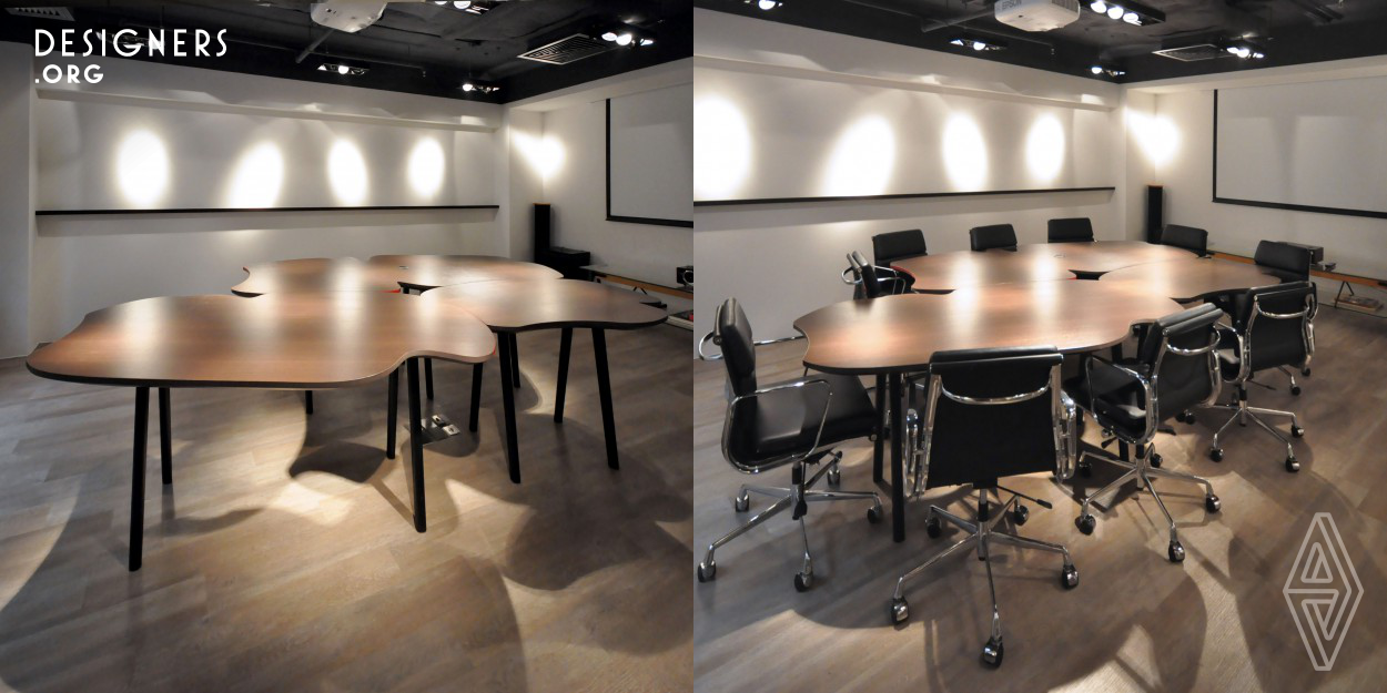 This table was designed by Bean Buro principle designers Kenny Kinugasa-Tsui and Lorene Faure. The project was inspired by the wiggly shapes of French Curves and the puzzle jigsaws, and serves as the central piece in an office conference room. The overall shape is full of wiggles, which is a dramatic departure from the traditional formal corporate conference table. The three parts of the table can be reconfigured in to different overall shapes to vary seating arrangements; the constant state of change creates a playful atmosphere for the creative office.