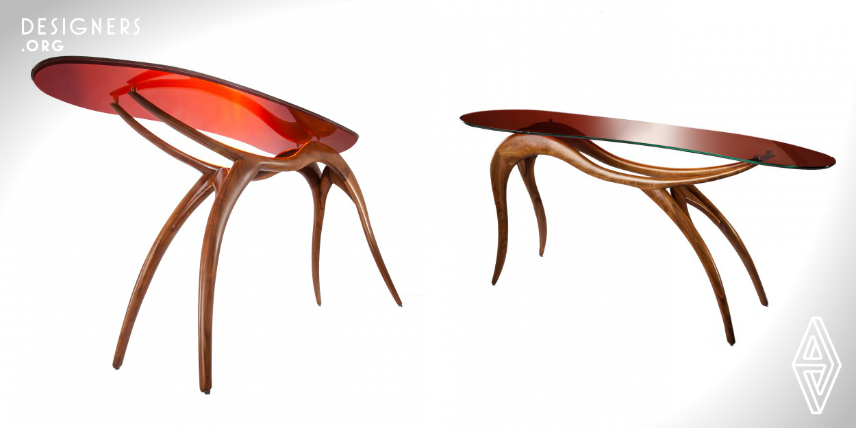 The organic and curved lines of this piece emulate a warm and daring sensation that balances half way between the futurist and the wilderness. The organic lines are only obtained with the involvement of an expert artisan. The wood is Tzalam, a very hard tropical wood from Central America. The top is made with laminated colored glass (18mm). This consoles forms part of the “Eros" collection, which uses the human body and the organic forms as inspiration, transforming them into a collection of furniture thoughtfully designed to evoke erotic feelings, harmony and beauty.