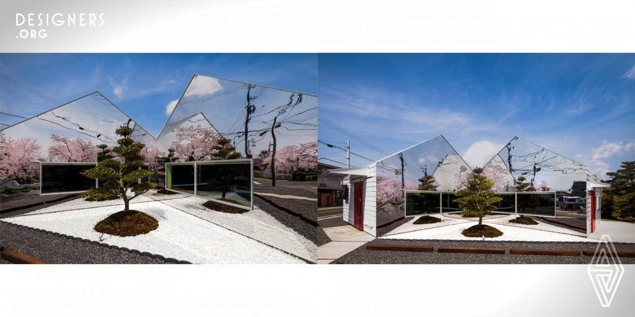 Mirrors is a roadside cafe designed for a plot by side of a row of cherry trees. The building has two wings and looks as if it has split in half symmetrically and arranged around a single Camilla tree, which stands on a patch of white gravel with tile edging. Internally, vertical roof struts of motif of the tree blanch make visitors feeling of a rest under the tree. A bank of cherry blossom is mirrored by the reflective gables. This feature creates a cherry forest in this residential town.