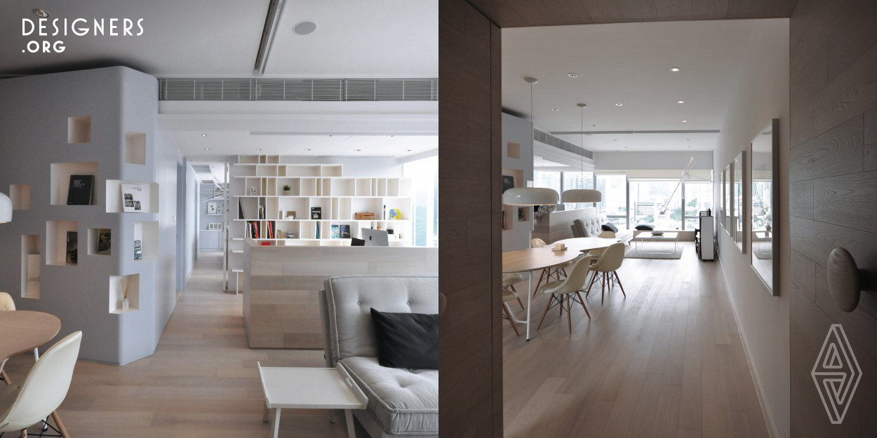 In response to the growing trend of working from home culture, Bean Buro designed the apartment with large panoramic windows facing the sea boating sceneries in Hong Kong Aberdeen. Drawing inspirations from traditional French boathouses in Brittany, the materials palette is natural, coloured and relaxing. The solution was to create an open space wrapped in natural timber, and a dove blue wall that adds to the fluid feel, luring the boundary between living and dinning areas.
