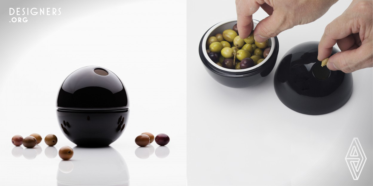 OLI, a visually minimalist object, was conceived based on its function, the idea of hiding the pits arising from a specific need. It followed observations of various situations, the ugliness of the pits and the need to enhance the beauty of the olive. As a dual-purpose packaging, Oli was created so that once opened it would emphasize the surprise factor. The designer was inspired by the shape of the olive and its simplicity. The choice of porcelain has to do with the value of the material itself and its usability.