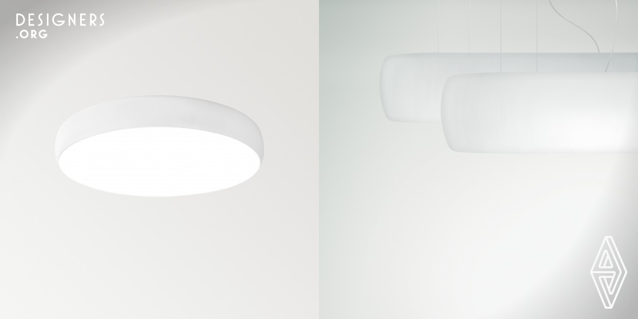 Large dimension recessed light, surface or suspended, offering major luminous flux and apt to be unhooked from the ceiling as you wish. Drum is dimmable, to adapt the light volume to the specific needs of each application.   Formally its design is expressed in a circular strip, slightly arched towards the center, and a minimum bezel. Perfect light diffusion in the entire illuminated surface and a seductive effect of natural light clarity.