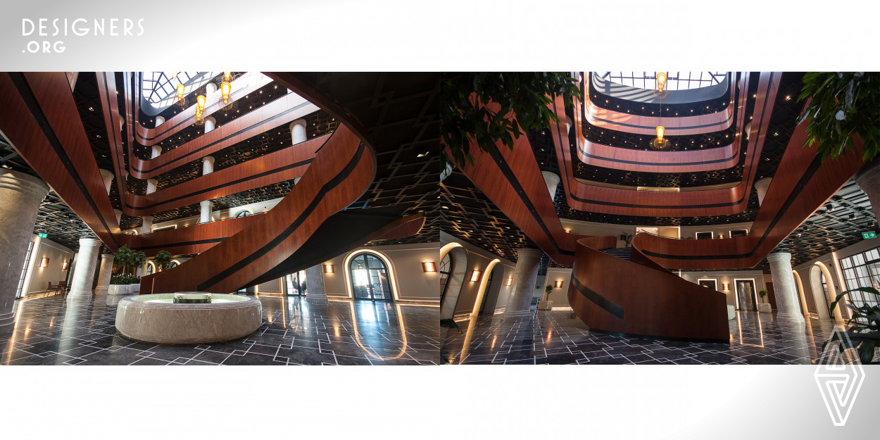 The building has an area of 8500 m2 with consisting of ground floor and four floors. Gallery space is therefore a circular staircase that ends in a wooden parapet on the ground floor and provide continuity from both the formal aspects are highlighted. This dynamic wooden structure has emerged as a ’’ knowledge spiral ‘’ with a conceptual approach. This is felt throughout the predominantly with spiral wooden structure in the building.The ceiling system is designed as a flying perforation an opposite form intertwined with wooden spiral. Ceiling system emphasizes the wooden spiral.