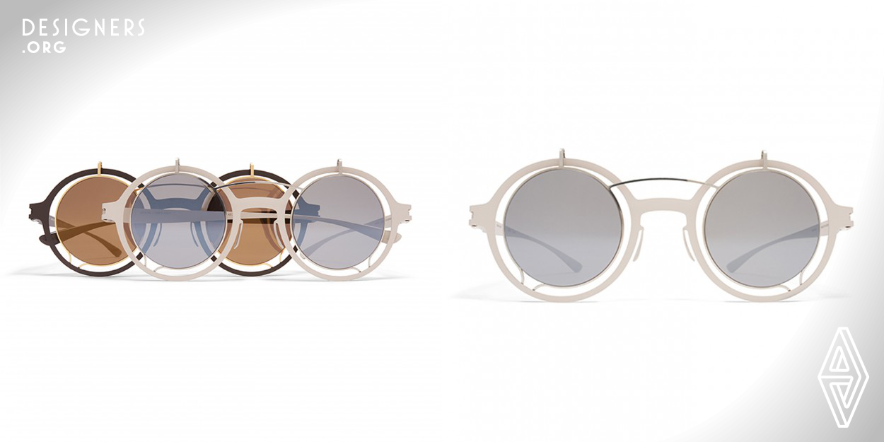 At first glance, the perfectly round MADELEINE appears to consist of two frames, but a closer look reveals the trompe l’oeil construction as an example of particularly sophisticated handcraft. Made of one piece the frame is essentially folded in half and brought into shape in a series of meticulous steps. The result is a distinctive aesthetic in which two delicate circular lenses hover in front of more solid round rims. Contrasting colours accentuate the layered concept.  