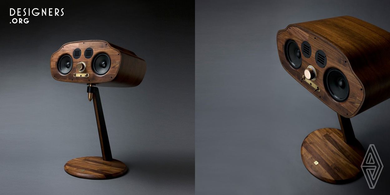 In the new millennium, where digital devices are striving to be minimal and inconspicuous, the Golden bug stands out against the inorganic trend. The speakers, embedded in birch plywood and reminiscent of the headlights and grill of a mid 20th century car, sit atop a thin neck that stems from its sleek, circular walnut base. As its facelike head turns on its screw-on neck, the Golden bug invites its audience to connect and reminisce in the glory of an acoustic memory. The Golden bug brings back a partnership between user and device and thus becomes the rediscovery of analogue emotions.