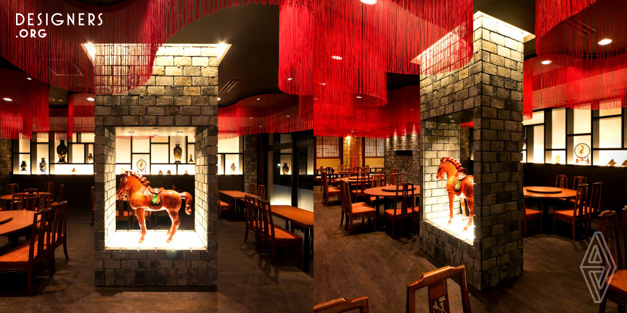 Pekin-kaku restaurant new renovation offers a stylistic reinterpretation of what a Beijing style restaurant could be, rejecting the traditional abundantly ornamental design in favor of a more simplistic architectonics. The ceiling features a Red-Aurora created using 80 meters long string Curtains, whilst the walls are treated in traditional dark Shanghai bricks. Cultural elements from the millenary Chinese heritage including Terracotta warriors, the Red hare, and Chinese ceramics was highlighted in a minimalistic display providing a contrasting approach to the decorative elements.