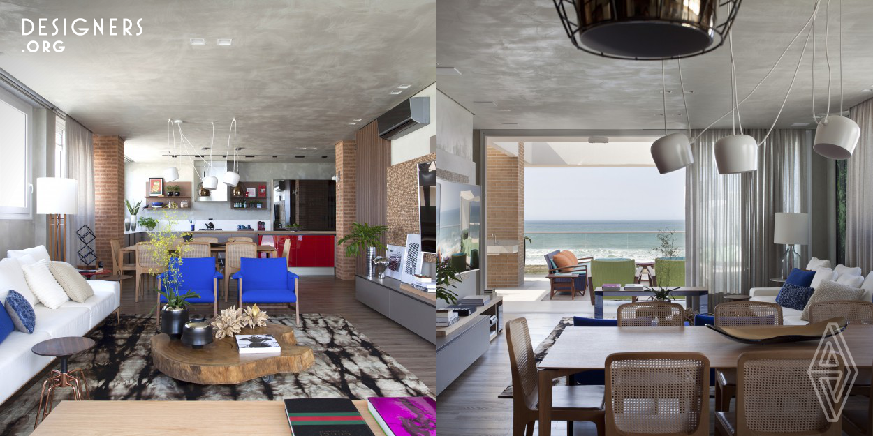 The project was inspired by the lifestyle of the customers. A young couple who love the contact with the surrounding nature and wanted the decoration of the penthouse apartment to convey features to remind them that they are near the beach, a relaxed decor and with many natural details such as wood. They wanted the apartment to have bright and strong colors. It was chosen the red, blue and green to command the decoration.The social area project is fully integrated with the kitchen, dining room, living room and terrace. The large doors that divide the living terrace are occasionally closed.