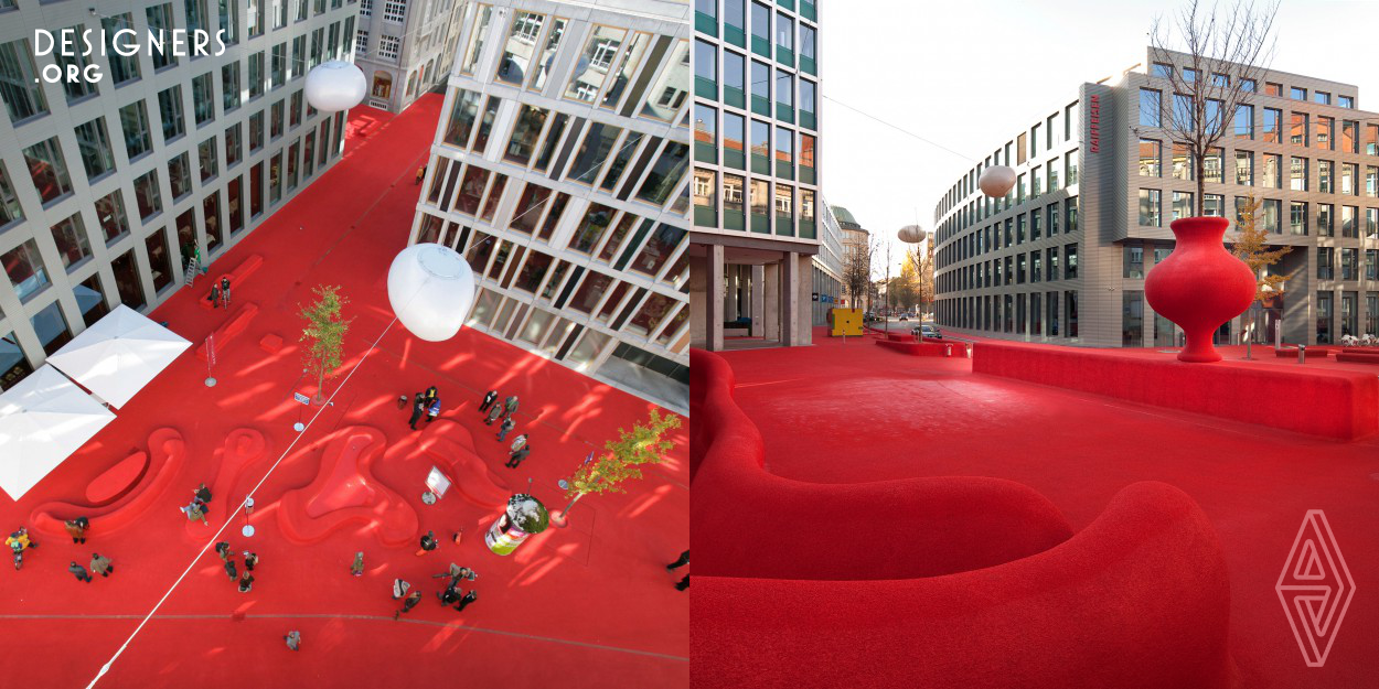 The granulated rubber flooring unifies every square and spared spot of the Raiffeisen quarter into a homogeneous whole. A particularly identity-building feature is its function as a haptically pleasant, cosy red carpet, that unfolds over the entire furniture. With its soft, pleasing material haptics, the amorphous silhouettes of the furniture present a deliberate contrast to the hard precision of the built surroundings.