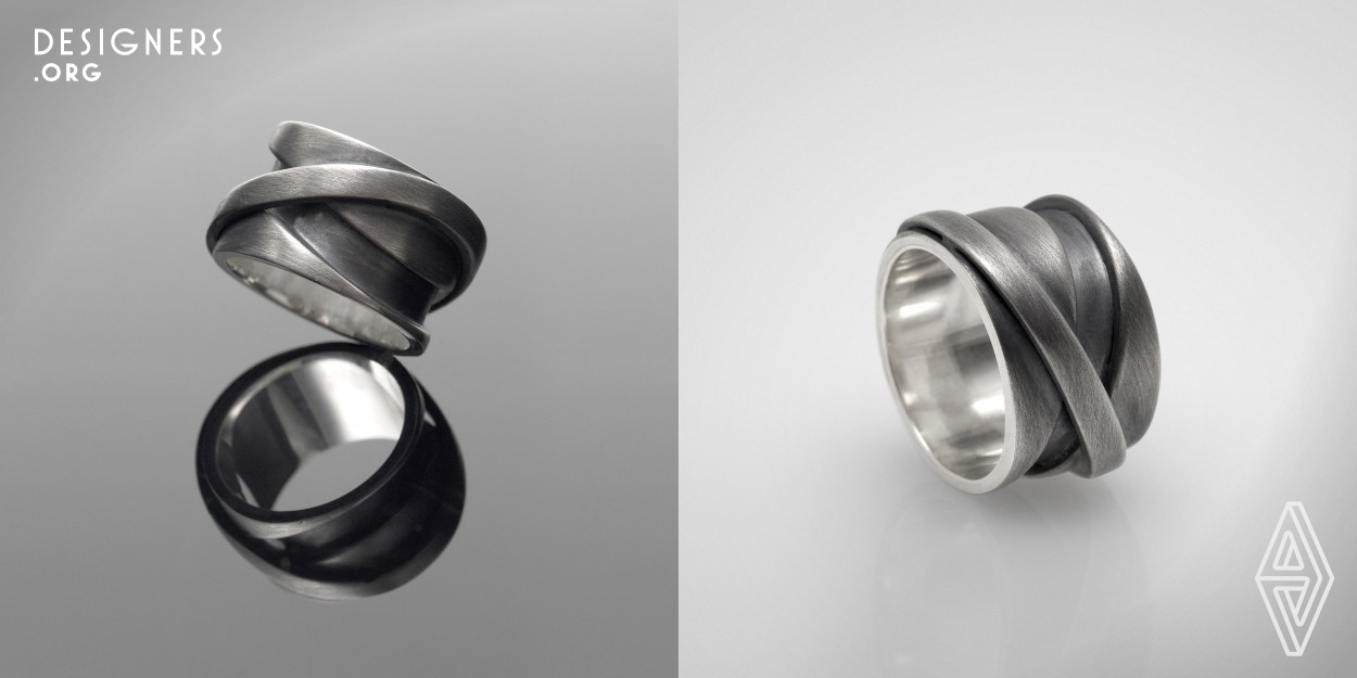 The Infinito ring came from the architectural lines and elements found in big cities. The concrete, the contrast between empty and filled spaces, the brutality and the structures of big metropolises, as well as its flow and continuity, led to the design of this piece. The jewelry consists of two volumes, kept apart and structured by an outer ring, on an unexpected diagonal axe. The multiple layers and the overlapping elements of the piece form a structure with a high contrast between volumes and voids, creating an intriguing complexity.