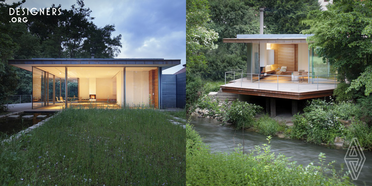 'Life in and with Nature' is the basic motif for the Haus Rheder, located directly on the Nethe River. The two completely glazed facades, one of which can slide almost completely open on the river side, blur the boundaries between interior and exterior. Reduction to the quintessential was the focus: light, air and tranquility. The design plays skillfully with the elements: a reflecting pool causes natural light reflections to develop on the ceiling, while a fireplace brings fire into the room. The highlight, however, is the terrace with a wide view into the surrounding landscape.