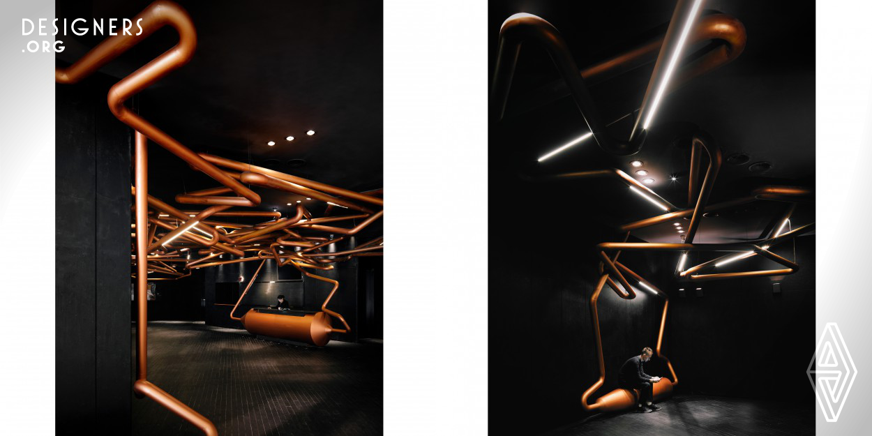 The rail used for filming tracking shots is adopted as the theme of this cinema, illustrated through copper colored metal tubes that stretch throughout the entire cinema. In the lobby, some of the tubes reach down and become seats, some enlarge and act as ticketing counters. Elongated lights are installed along the tubes, adding varieties and illuminate the space. In the auditorium, the walls are decorated by segments of metal tubes with lighting at both ends to enhance the lighting effect.