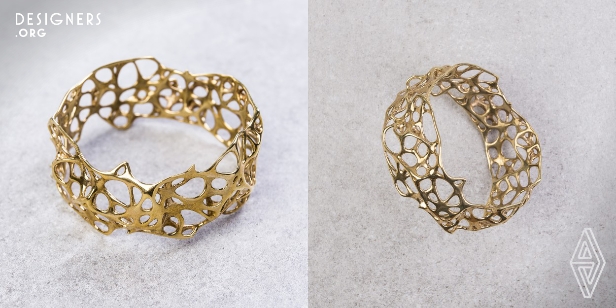 The form of Phenotype 002 bracelet is the result of digital simulation of biological growth. The algorithm used in the creative process allows imitating the behavior of biological structure creating unusual organic shapes, achieving unobtrusive beauty thanks to optimal structure and material honesty. The prototype is materialized using 3D printing technology. In the final stage, the jewelry piece is hand-cast in brass, polished and finished with attention to detail.