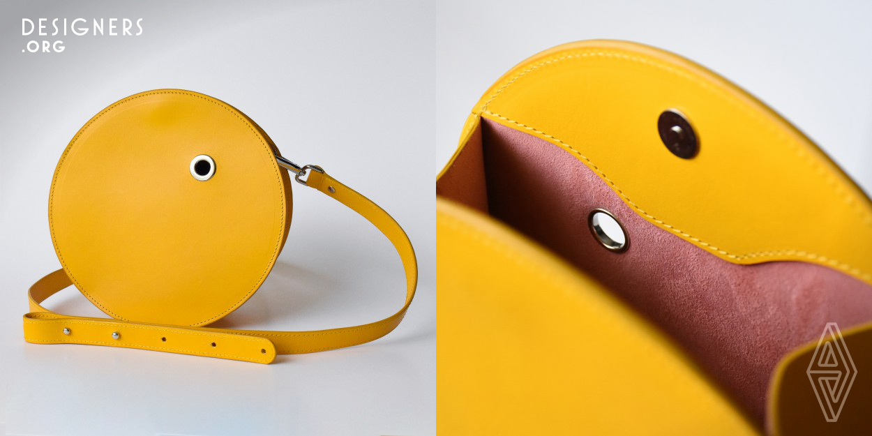 The Drop bag is a leather bag which is round outside and square inside. Its construction helps to keep the bag stable when it is placed on a surface and helps to keep insides organized. The design of the bag represents modern graphic design and minimalism. The project is developed together with the packaging to enhance visual impression of the concept. 