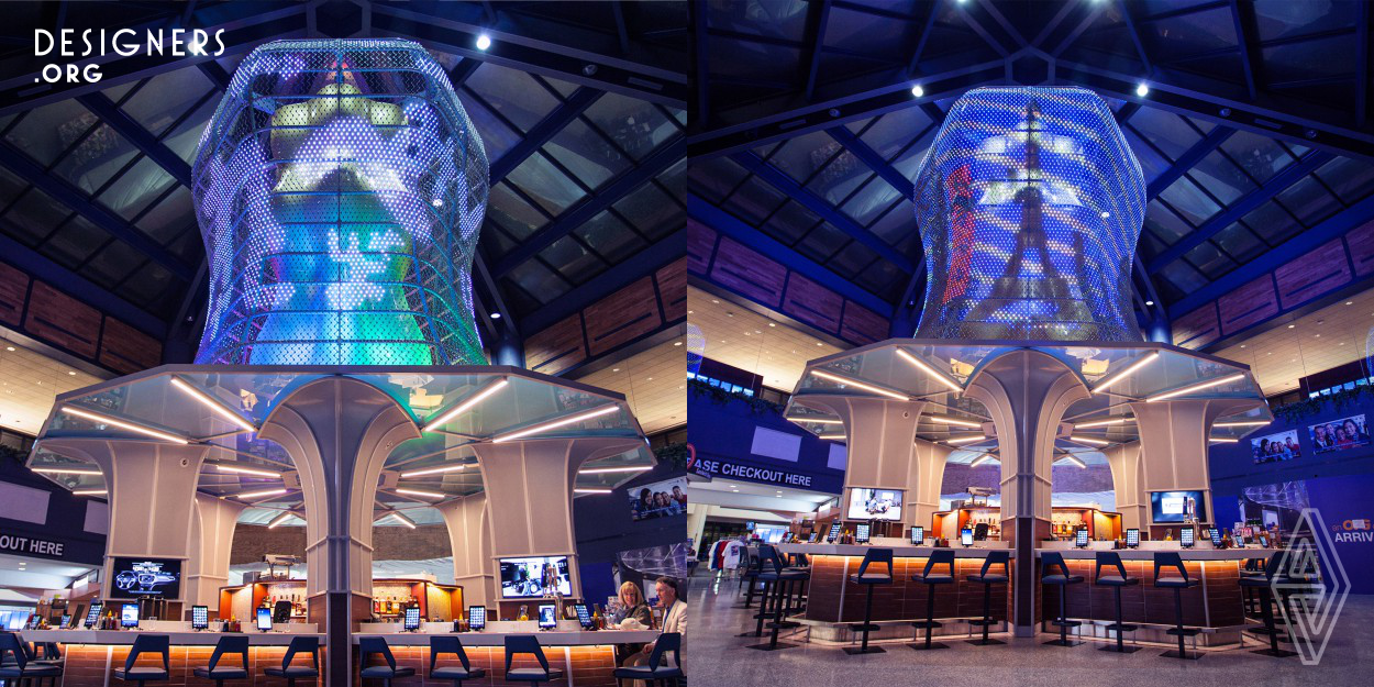 Kaedama is a modern Asian noodle bar at Newark Airport's Terminal C. The cornerstone of this restaurant is the forty-foot sculpture located above it, in the form of an abstract gold noodle wrapped with a hand-woven LED light mesh. The mesh features 17,000 interconnected lights that display animated designs and creates a dynamic setting. The animations and choreographed lighting have been integrated to highlight the curvature in the design of the structure. To add to the experience, the chefs stand on a platform directly under the sculpture to highlight the theater of making fresh noodles.
