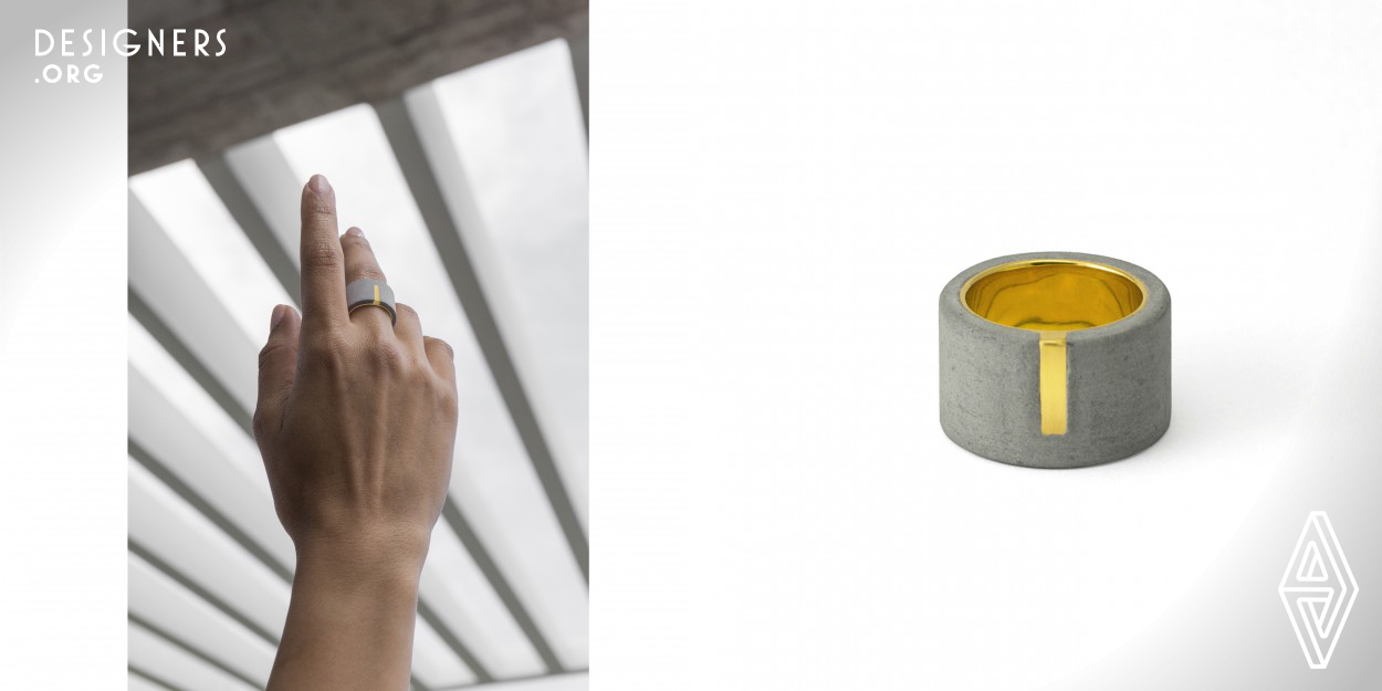 Tonos is a limited edition handmade ring consisted of two materials with diverse properties. A 14 karat gold cylindrical core interlocks with an external layer of grey concrete. Tonos is a punctuation mark specifying the correct pronunciation of a word. Driven by the actual use in Modern Greek language, the name is used in a metaphoric way. The projected segment of the gold core is intentionally employed to emphasize the transition of the materials and balances the shiny and matt side of the object. Each piece is unique, numbered and available in a variety of precious metals and colors.