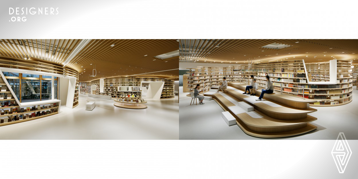 A library designed by a huge bookshelf with a curved line like the flow of a river, named "BOOK RIVER". The bookshelf changes various heights, becomes a seat, becomes a counter, or encloses a space like a wall. Big holes in the bookshelf, it becomes a tunnel, a window, a space like a capsule. This space has made various relationships between books and people, and created rich communication. 
