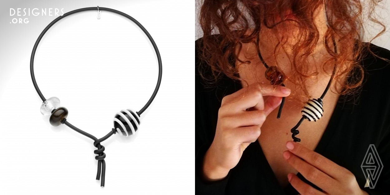 This is the Pianeti "Nodo" a unique necklace because of the way it has been thought, designed and created by Maria Laura. It closes on the front without the need of a classic closure thanks to its construction concept. The way it closes is its particularity. As a matter of fact the design is both functional, ergonomic, original and modern at the same time. The pearls are of Murano blown glass in this specific case but they can change according to the will of the designer, to the requests of private clients or to the fashion trends of the moment. The structure remains the same though. 