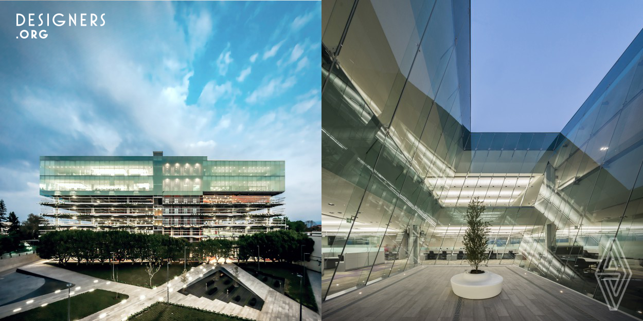 As the second phase of a 40,000 sqm. expansion, this structure transcends in the context as a well-ordered volume with clean geometries linked to the campus through a plaza, while serving as a visual buffer also improves the flow of people to the edifice within the corporate campus. Due to the building's tallness, the architect accommodates at its top a light glazed upper mass having positions for 1,143 users on 2 floors of 6,000 sqm. each. The design firm afterwards decided to have four interior patios which gain natural light, also improved the functionality between each business division.