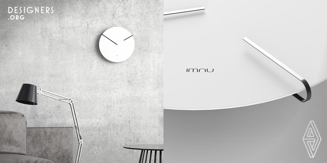 Imnu introduces a remake of a design classic, an original approach to the knownl wall clock. The focus in this design lies on the pointers of the clock. Instead of being attached to a pin in the middle of the dial, they run around the circumference. The clock face is a thin disc which seems to float on the wall. The designer‘s decision to leave the dial free of anything has a surprising effect as the hands come from behind the disc, folding themselves over the outer edge. The wall clock Imnu stands out thanks to its unconventional and minimalistic nature.