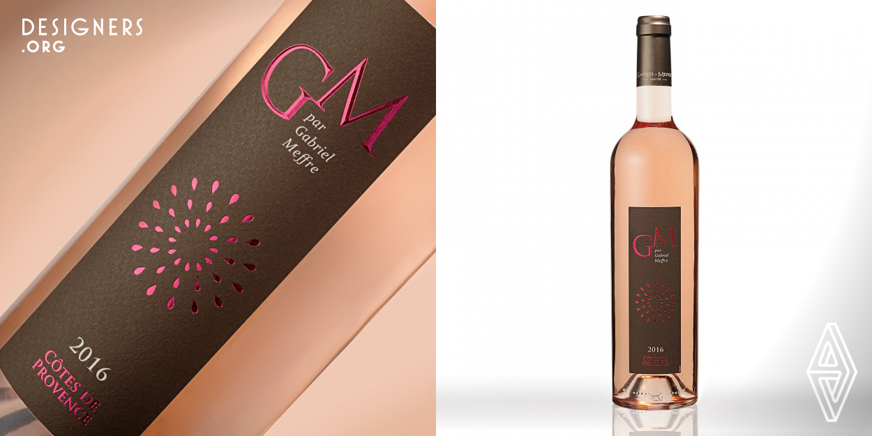 Our design focused on the summer side of the rosé. Rosé wine is best enjoyed in summer. The French rosé wine side and its summer fireworks are represented here graphically by a simple and impacting iconography. The colors pink and gray make an elegant and chic side to the bottle and the product. Moreover, the shape of the label worked in a vertical way adds this French touch to the wine. We also worked on initials GM graphically. The initials GM represent Gabriel Meffre and are worked with hot gilding, as well as an embossing on the letters and the splinters of the fireworks.