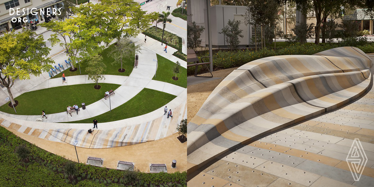 Located near a retail street West Palm Beach, this creates a featured amenity for visitors and locals alike. A sculptural seating piece made of laminated natural stone slabs acts to retain a rain garden managing storm water on site. The project drapes all native stone materials across the site to create a wave-like form. These stone slabs start from the plaza paving and sweeps upward to create the bench for people to sit. Visitors can sit in the shade of the canopy trees and view the integral art piece, or interact with the sculpture itself, finding ways to sit, stand, lie and climb.