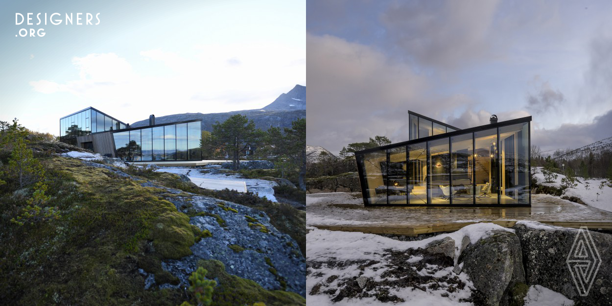 The cabin in Efjord is designed to interact with the natural terrain and provide its owners with both panoramic views of the landscape, but also total privacy. The conceptual layout of two volumes addressing opposite directions underline this, but also reflects both the natural surroundings and the functional requirements. The site is set between majestic mountains with famous climbing routes and a panoramic panorama over the fiord.