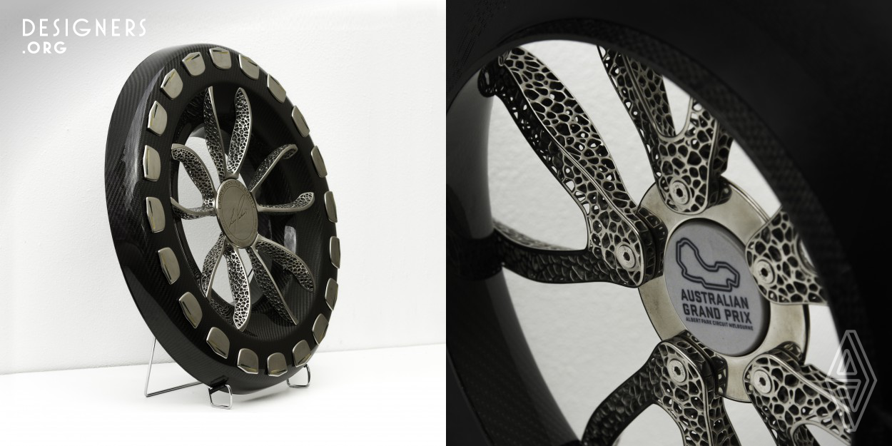 The Larry Perkins Trophy for Formula 1 Australian Grand Prix is a unique trophy that celebrates the engineering contributions that Formula 1 and Touring Cars driver Larry Perkins has made to motorsport. The Design consists of Carbon Fibre unibody that is generated in VR with five spoke design as a algorithmic generative structure fabricated with Titanium 3d printing. The outer rim of trophy contains 20 winning drivers nameplates that mimic rear race car  defusers, these are also 3d printed in titanium.