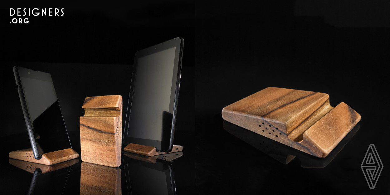 A pocket holder for phones or tablets, as small as it gets, adapted for video viewing and video communication. Designed from a piece of noble walnut wood of pleasant touch and with unique natural pattern. The softly shaped oblique lines define the ergonomic usefulness of different phone positions, ensuring stability, multifunctionality and an open screen. The volume of the body is hollow, filled with electronics for wireless phone charging, optional Bluetooth speakers and is discretely closed by a convenient mirror on the back. A piece of living nature combined with sophisticated electronics.