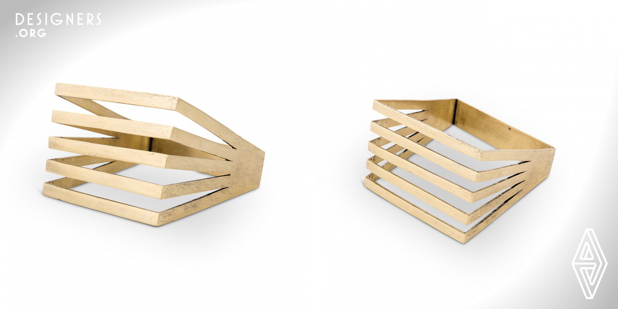 The Geometric Square bangle is reflection of the modern woman of today. It is easy and comfortable to wear. The design has been created using square metal frames placed at different angles, merged towards the main square at the center. The design creates a 3D form and the angles create a pattern. There is a sense of mass and void and the openness of the design depicts a sense of freedom. This form looks like a miniature of a pergola in architecture. It is minimal and clean, yet edgy and statement. The design is created using metal only. Materials used: Brass (gold plated/rhodium plated)