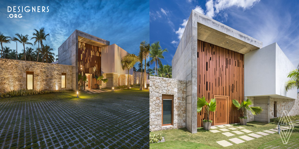 It located in Portillo Beach, Las Terrenas. The housing of 850 square meters of construction has a high-end finish. The design is based on the integrity of the materials and how they blend into the Caribbean beach landscape: the natural gypsum floor, the unpolished travertine stone floor, coral stone and aluminum with wood finish, among others. The design design consists of a combination of different textures, elements and volumes. This manages to be balanced and with a good management of the materiality, being distinctive in its facades the concrete in its natural state.