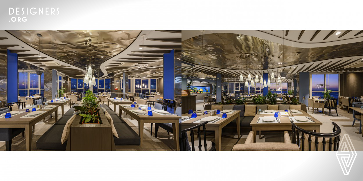 The design of the restaurant is based on the principle of reflection.  Surrounded by the coastline sea and open sky, the interior walls are cladded with tampered metal sheets as the main interior element flowing like water throughout the space, reflecting the light of the environment around it.  The different tone of blue on each column tries to reflect the ever changing tones of the blue sky.