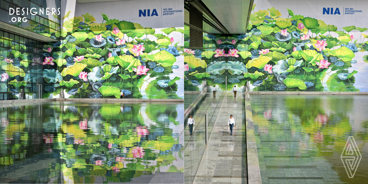 Upon arrival at the Noi Bai international airport visitors are welcomed by twin murals depicting lotus ponds in full bloom. The lotus, the national flower of Vietnam, was selected as the focus for 2 impressive 720 sq. meter outdoor murals painted on the facade of the T2 terminal. For over 2 months, lead designer Thu Thuy and New Hanoi Arts company worked creating these 15 meter high murals which were unveiled in January 2019. The blooming lotus reflecting in the pool and in the terminal’s glass windows, creates a sense of endless beauty and peace, a surrealism first impression of Hanoi.