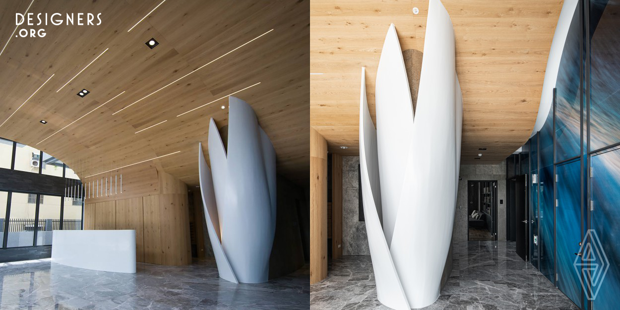 Applying a large sculptural shape to reshape the space and create a visual focus. First, make a large curved ceiling with a wood texture at the entrance height, and form a base at the bottom of the curve. Then on the right side, the shaft column is decorated into an ellipse, and the surface is surrounded by three lotus petals. In the visual experience, it is like a "the budding lotus" carrying the entire lobby space.