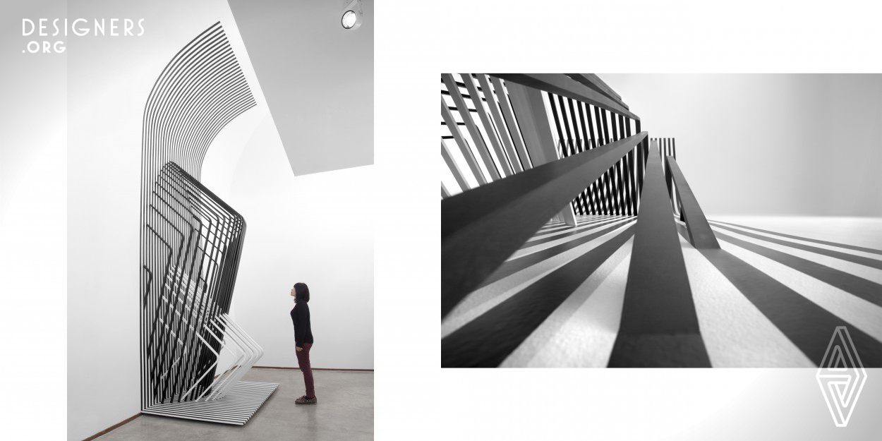 Visual illusions are created when 2D graphics merge with 3D structures. Here, black and white 2D vinyl strips extend into 3D space via black and white wood structures. This creates a Moire effect. As the viewer perceives the sculpture and approaches it from different angles, patterns change. Lines intersect in different manners leaving the viewer wondering. What is creating these patterns? Why are they changing? The viewer is involved and puzzled.  Installed at the art museum, the sculpture with its wood structure return merges with the existing curved ceiling. Ceiling and sculpture appear as one. 