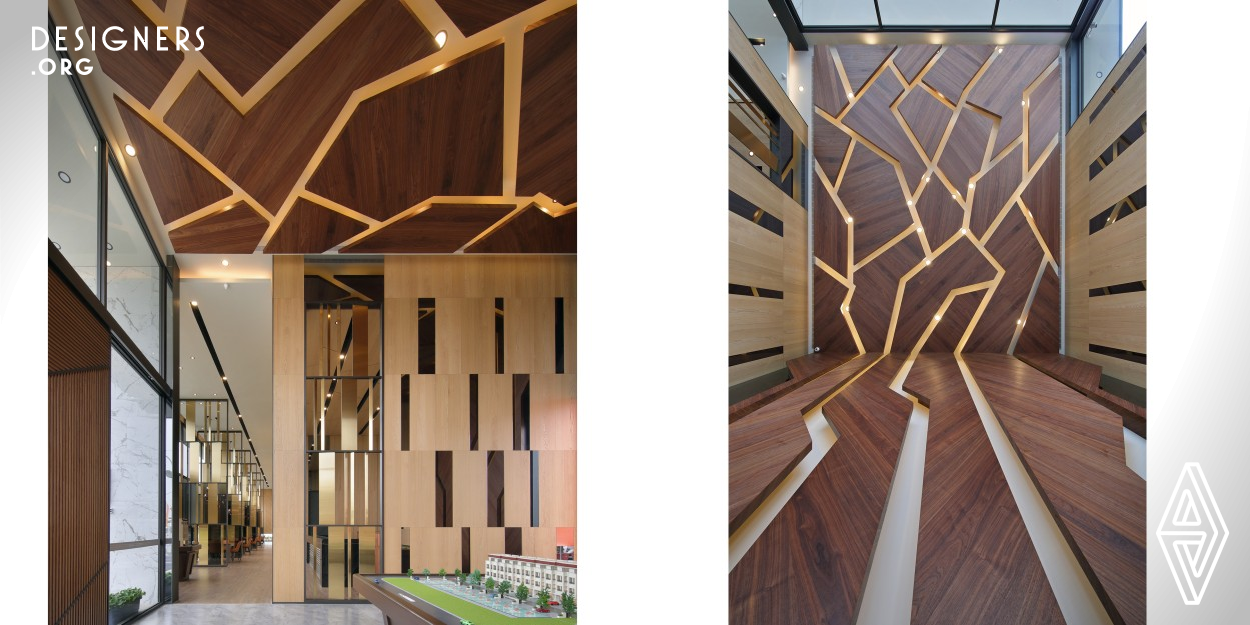 The design idea, therefore, is based on the kiln culture. Near the front entrance at the right building facade, the exhibition space is decorated with the gorgeous patterns resembling the unique ice cracks exclusively produced for the high temperature roasting. The irregular big shapes of wood boards decorated along the way from the wall to ceiling mimic the artistic patterns of the ice cracks. As the wall and ceiling lights shining through the gaps between the wood boards, the exhibition space dazzles through the windows. The exclusive features of golden wire and purple iron foot.