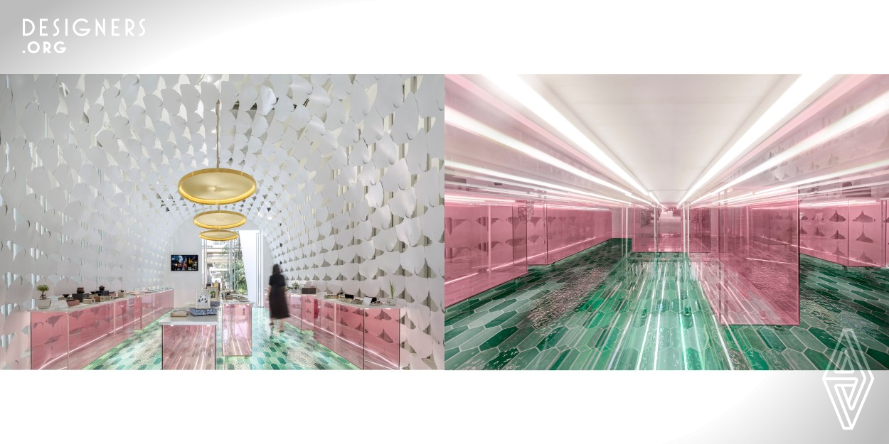 The appearance of this case is designed around the concept of box. The frame of the exhibition hall is a domed space, which is composed of white metal plates in the shape of Ginkgo leaves and is full of Chengdu's urban cultural characteristics. The pink counter is listed orderly on the green floor tiles. At the end of the exhibition hall is the reception hall for customers to enjoy tea. The design of the reception desk is in the shape of Western Sichuan folk house with blue bricks and grey tiles, showing the unique tea house culture of the city with the reputation of leisure capital.