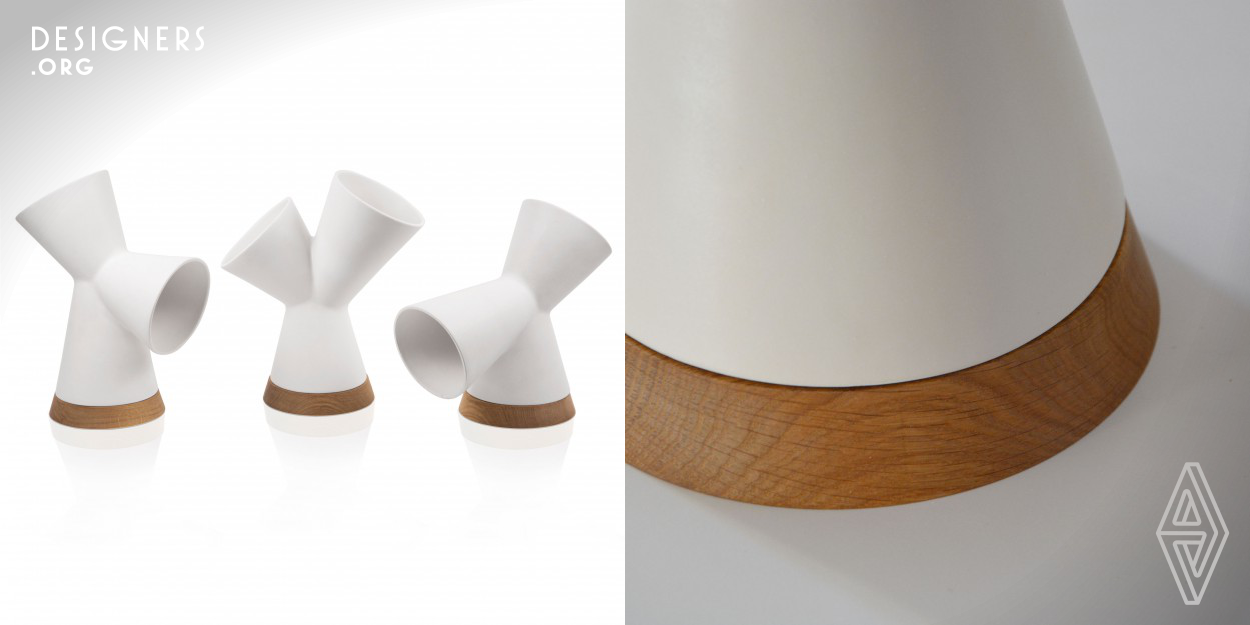 Oplamp is composed of a ceramic body and a solid wood base on which an led light source is placed. Thanks to its shape, obtained through the fusion of three cones, the Oplamp's body can be rotated to three alternative positions that creates different types of light: high table lamp and ambient light, low table lamp and ambient light, or two ambient lights. Each configuration of the lamp’s cones allows at least one of the beams of light to interact naturally with the surrounding architectural settings. Oplamp is designed and made entirely by hand in Italy.